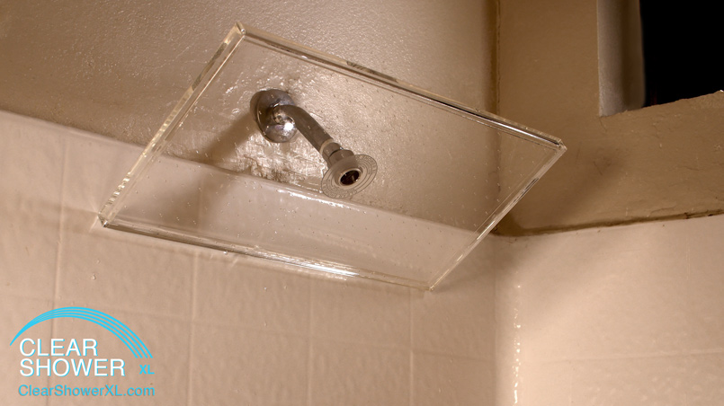 large clear showerhead with white tile
